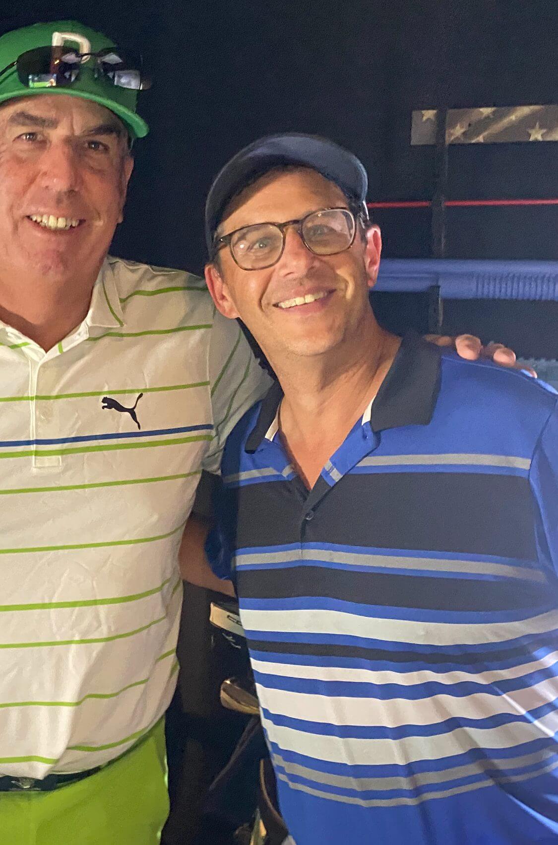 Two men smiling in casual attire.